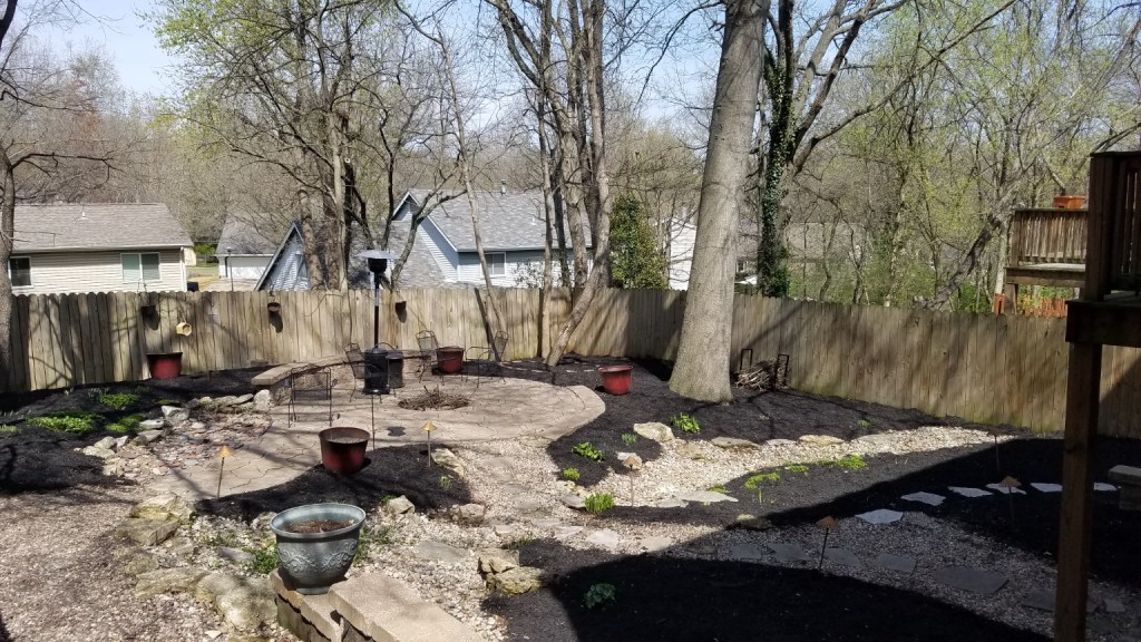 Backyard landscape renovation with mulch, rock, paths and planting beds by Prayers Lawn & Landscape